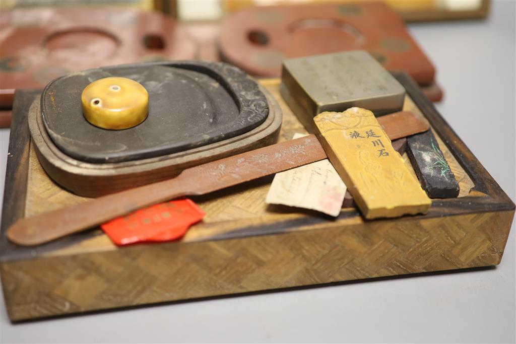 A group of Chinese and Japanese objects, 19th/20th century, including an inscribed ink box an inkstone, a lacquer bookslide, two Tibeta